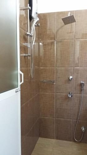 a shower with a glass door in a bathroom at Polhena Coral Reef Resort in Matara