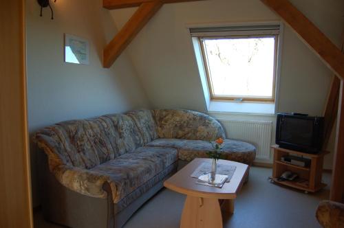 a living room with a couch and a table at Heu-Ferienhof Altkamp in Putbus