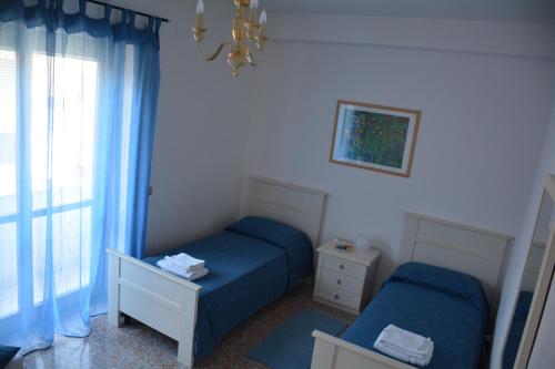 a small bedroom with two beds and a window at Andreina a San Pietro Apartment in Rome