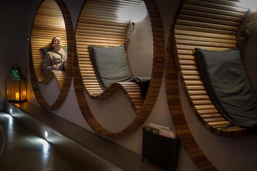 a person sitting in a chair in front of a mirror at Auchrannie Resort in Brodick