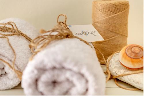 a pile of towels and donuts on a shelf at Anemologio in Finikas