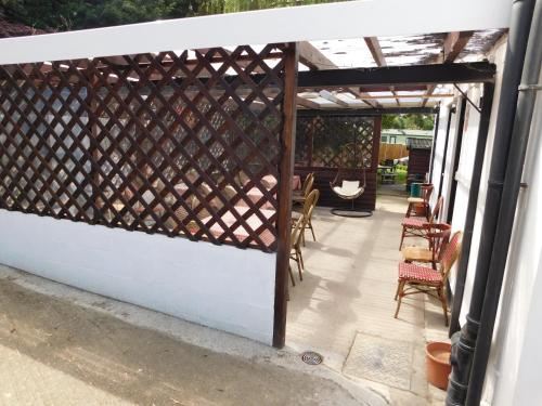a pergola with a fence on a patio at The Railway Inn in Forden