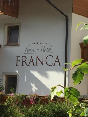 a sign that reads camp hotel franca on the side of a building at Garni Franca b&b in Selva di Val Gardena