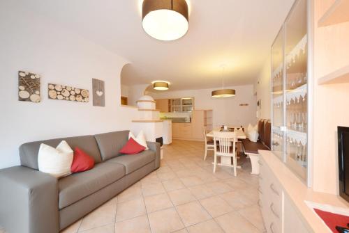 a living room with a couch and a dining room at Mason La Zondra in Vigo di Fassa