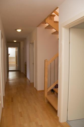 a hallway with a staircase in a house at Schlafgut Küssler - 70m vom City Express in Zell am See