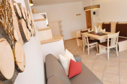 a living room with a couch and a dining room at Mason La Zondra in Vigo di Fassa