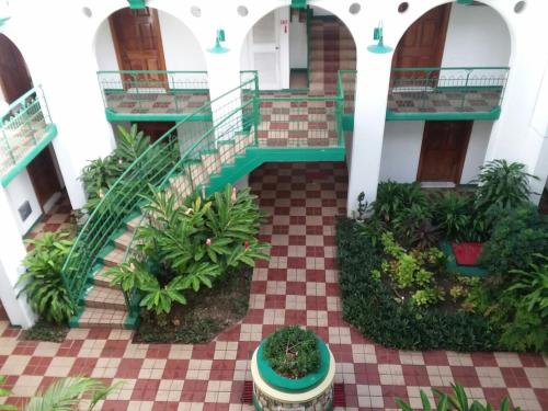 arium of a building with a staircase and plants at Castle by the Shore in Ocho Rios