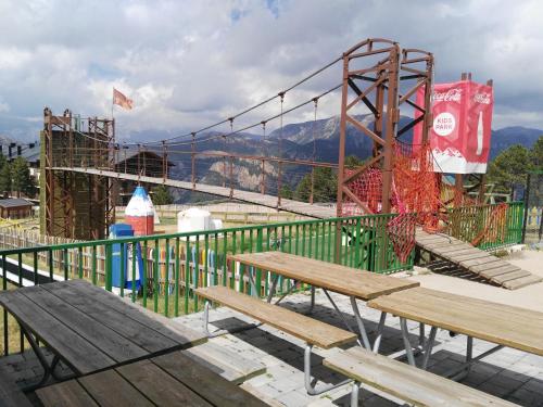 a playground with benches and a roller coaster at Lujoso duplex en Port del Comte in La Coma i la Pedra