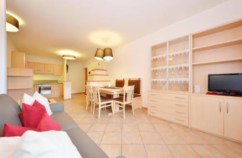 a living room with a couch and a dining room at Mason La Zondra in Vigo di Fassa