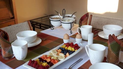 a table with a tray of fruit and eggs on it at Campbell Cottage B&B in Nanaimo