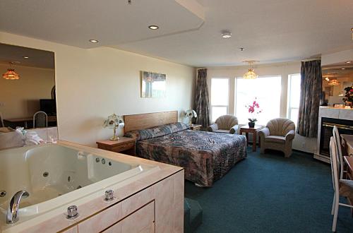 a hotel room with a bed and a bath tub at Western Budget Motel Bonnyville in Bonnyville