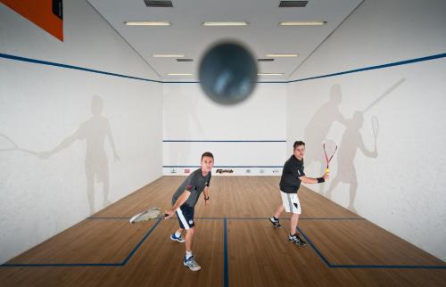 two men playing a game of tennis in a gym at Ninety Hotel in Sao Paulo