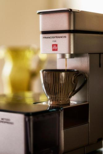 a coffee maker with a cup on top of it at B Montmartre in Paris