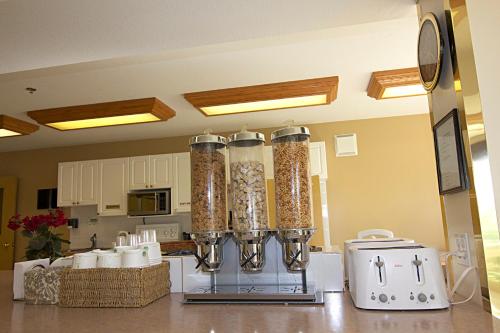 a kitchen with two glass containers filled with food at Western Budget Motel Bonnyville in Bonnyville