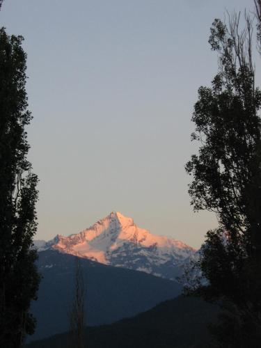 a snow covered mountain in the distance with trees at Breckenbreck monolocale CIN IT7001C2P4NVWOPA in Allein