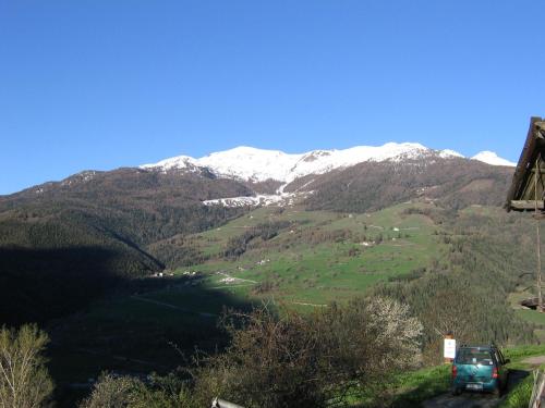 a car driving down a road with mountains in the background at Breckenbreck monolocale CIN IT7001C2P4NVWOPA in Allein