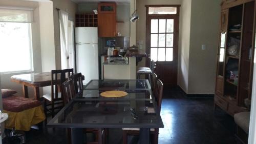 a kitchen with a table and chairs and a refrigerator at Quinta Siete Soles in Tandil
