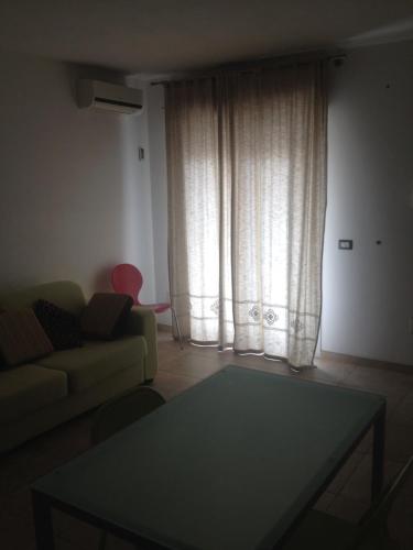 a living room with a couch and a table at fausthome in Assemini