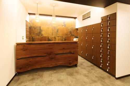 a locker room with a large wooden chest of lockers at Guest House Wagokoro in Tokyo