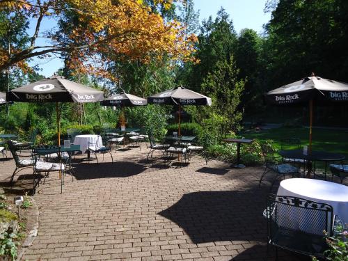 a group of tables and chairs with umbrellas at Benmiller Inn & Spa in Goderich