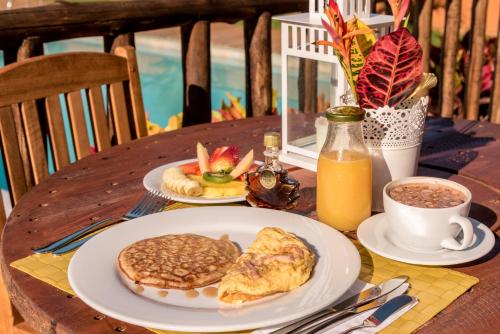 a table with plates of breakfast food and a cup of coffee at Hotel Boutique Venturi in Barichara