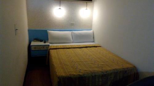 Postel nebo postele na pokoji v ubytování Reui Chung Hotel