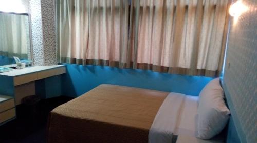 Postel nebo postele na pokoji v ubytování Reui Chung Hotel