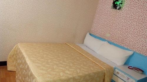Postel nebo postele na pokoji v ubytování Reui Chung Hotel