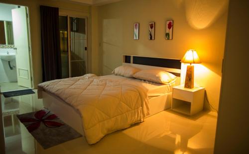 A bed or beds in a room at The Suvarnabhumi Apartment