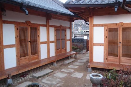 a building with wooden doors and windows on it at Sarangroo in Jeonju