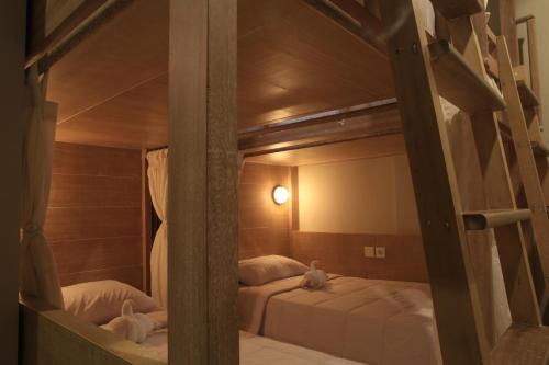 two bunk beds in a room with a mirror at Poshtel Ubud in Ubud