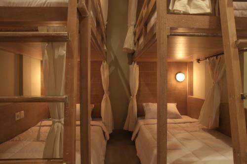 a room with two bunk beds in a house at Poshtel Ubud in Ubud