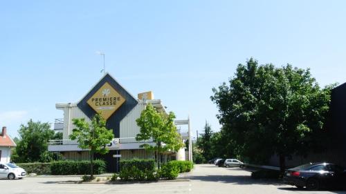 a building with a sign for a hotel at Premiere Classe Lyon Sud - Chasse Sur Rhône in Chasse-sur-Rhône