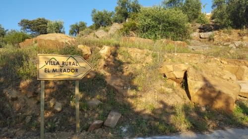 a sign on the side of a road at Villa Rural El Mirador in Alora