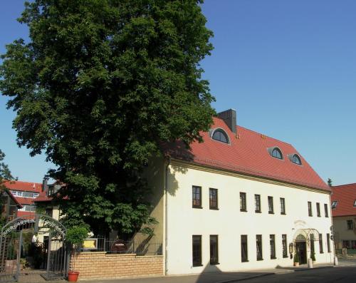 a large white building with a red roof at Hotel & Restaurant Klosterhof in Dresden