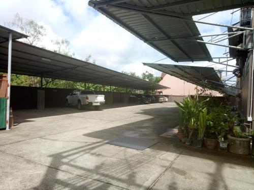 a parking lot with a car parked under awning at Centerpoint Hotel in Trang