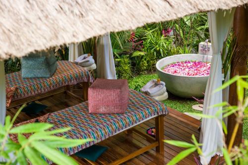 a room with two chairs and a bath tub at Calma Ubud Suite & Villas - Rice Fields View, Infinity Pool ! in Ubud