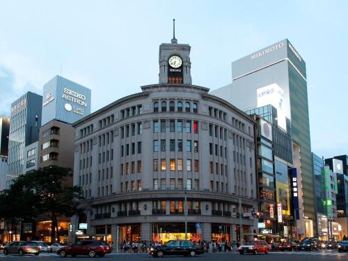 a large building with a clock tower on top of it at APA Hotel Shinjuku Kabukicho Tower in Tokyo