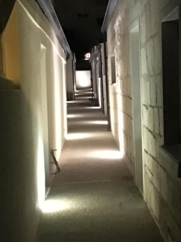 a hallway with white lights in a building at Le Clos du Square - climatisé in Rochefort