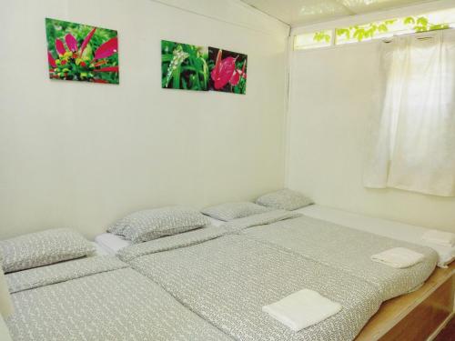 a bedroom with two beds and a window at Moonriver Lodge in Cameron Highlands