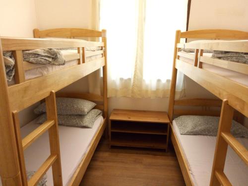 two bunk beds in a room with a window at Moonriver Lodge in Cameron Highlands