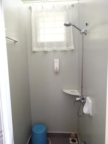 a white bathroom with a sink and a window at Moonriver Lodge in Cameron Highlands