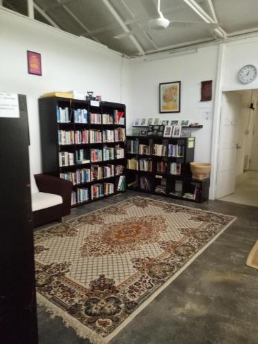 a room with bookshelves and a rug on the floor at Moonriver Lodge in Cameron Highlands