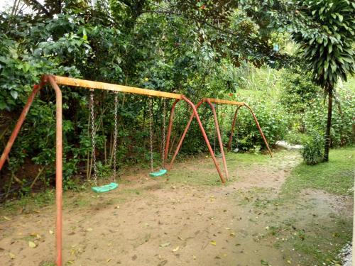 an old swing set in a park at Moonriver Lodge in Cameron Highlands