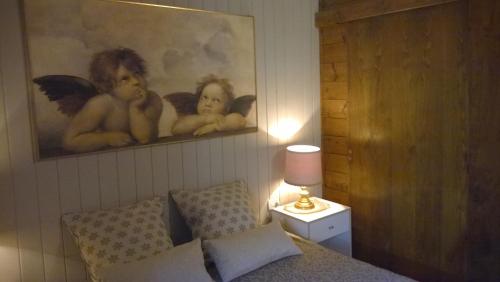 a bedroom with a picture of naked babies on the wall at Chalet Do Costa in Pozza di Fassa