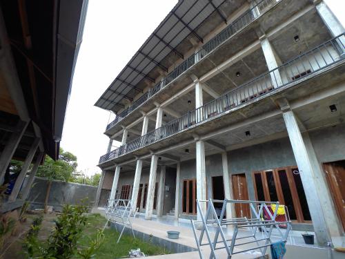 an external view of a building with a balcony at Eddie's Homestay in Lhonga