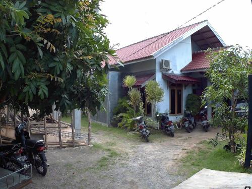 a group of motorcycles parked in front of a house at Eddie's Homestay in Lhonga