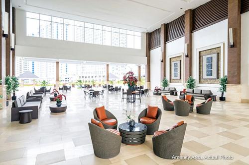 a lobby with couches and chairs in a building at Taal View Condo by Liza in Tagaytay