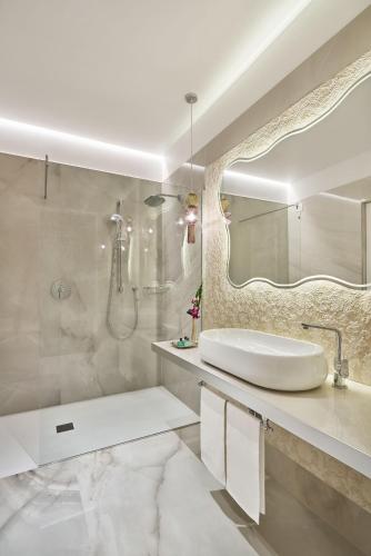 a white bathroom with a sink and a mirror at Grand Hotel Duchi d'Aosta in Trieste