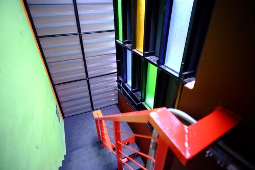 ピサヌロークにあるNap Corner hostelのカラフルな窓が備わる客室のオーバーヘッドビュー